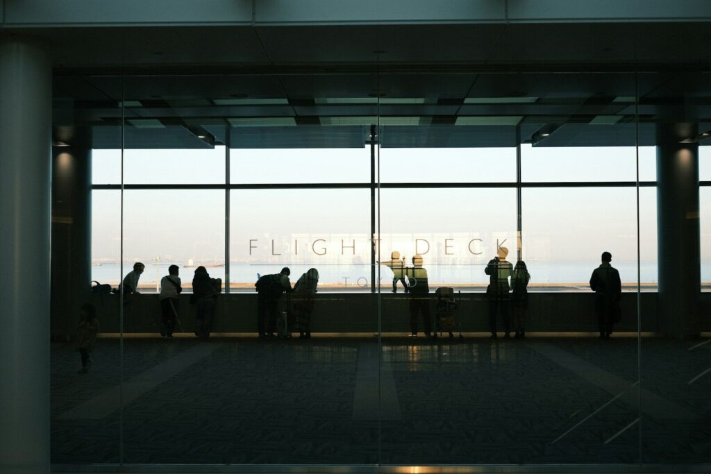 A group of people standing in front of a window